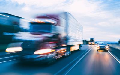 Cars and trucks driving on a highway.